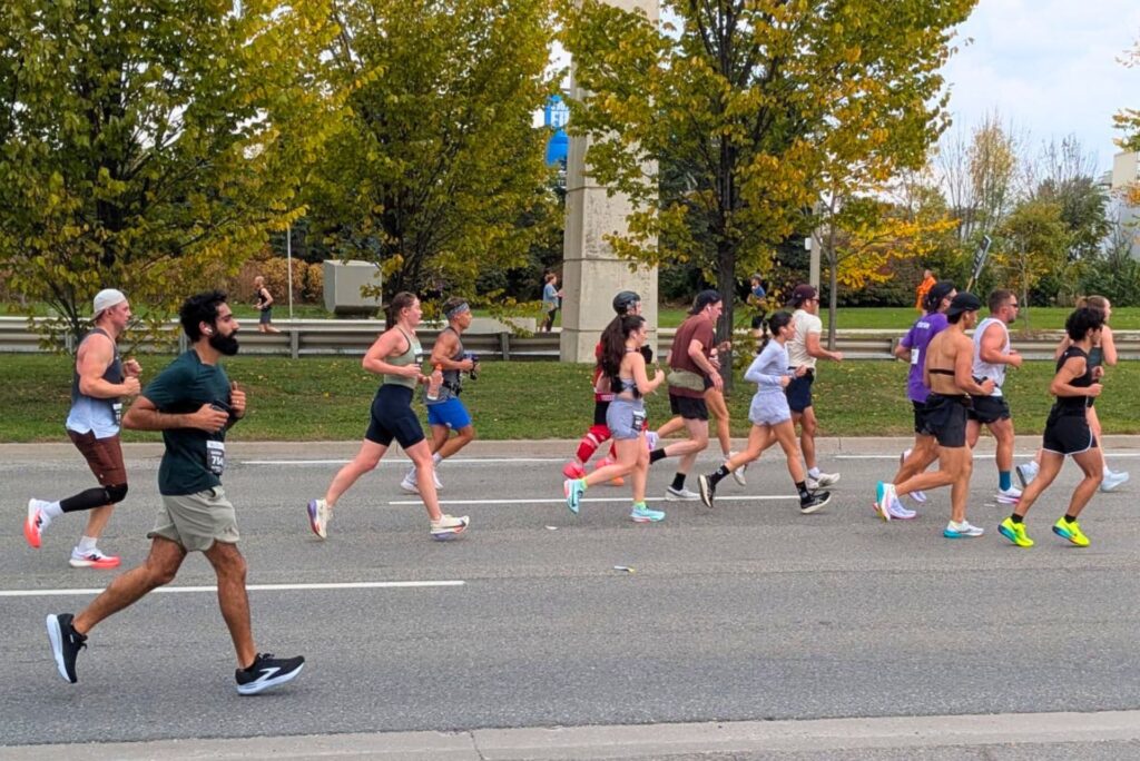 A group of runners running the Toronto Waterfront Marathon.