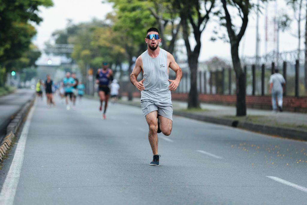 A man running a road race on a hot day.
