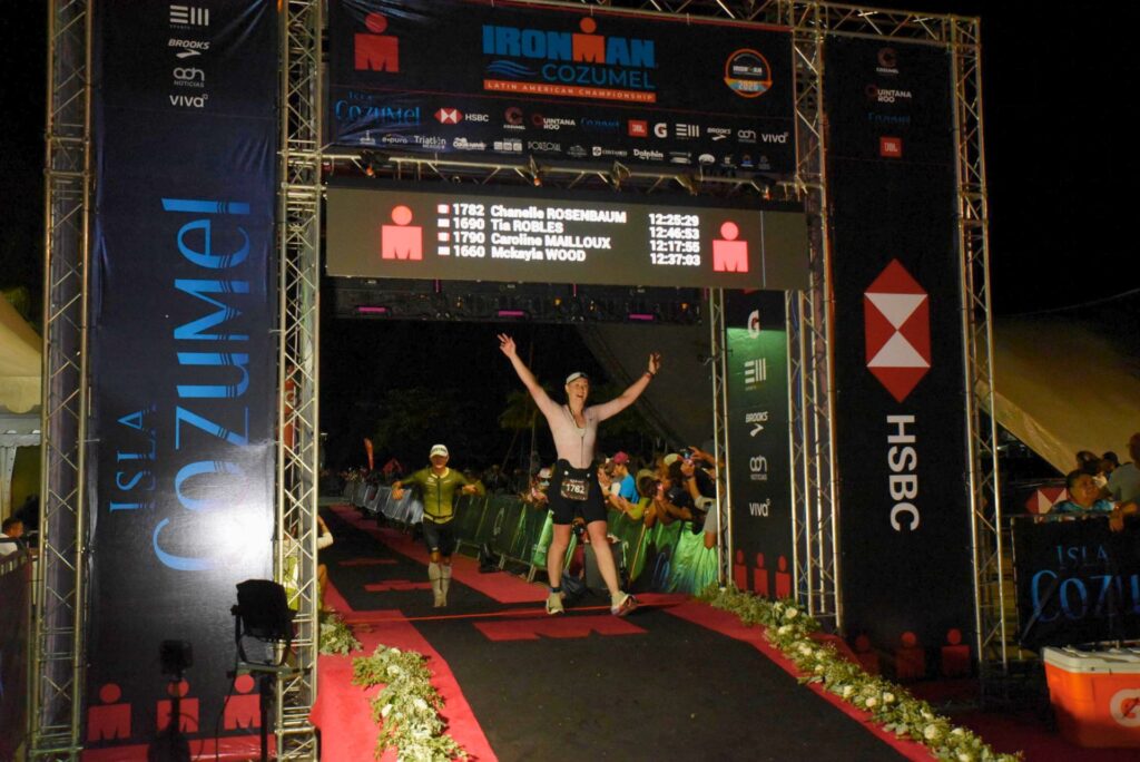 Crossing the finish line at Ironman Cozumel.