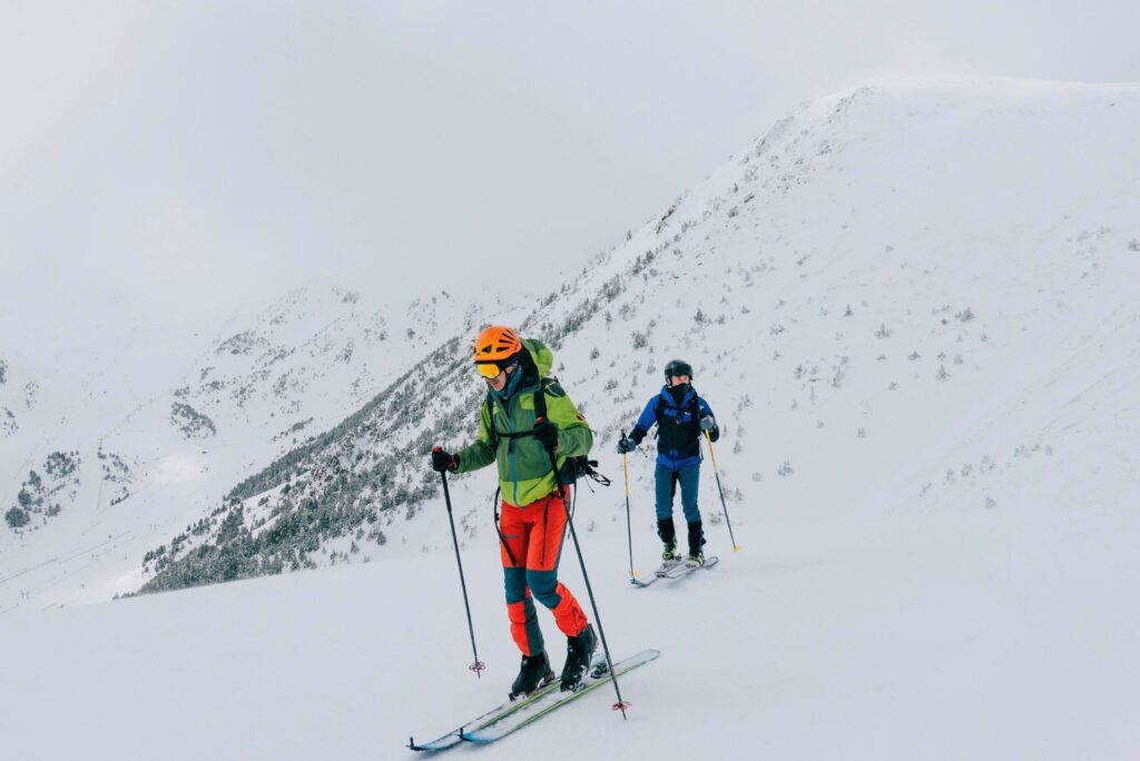 Two athletes ski touring in the backcountry.