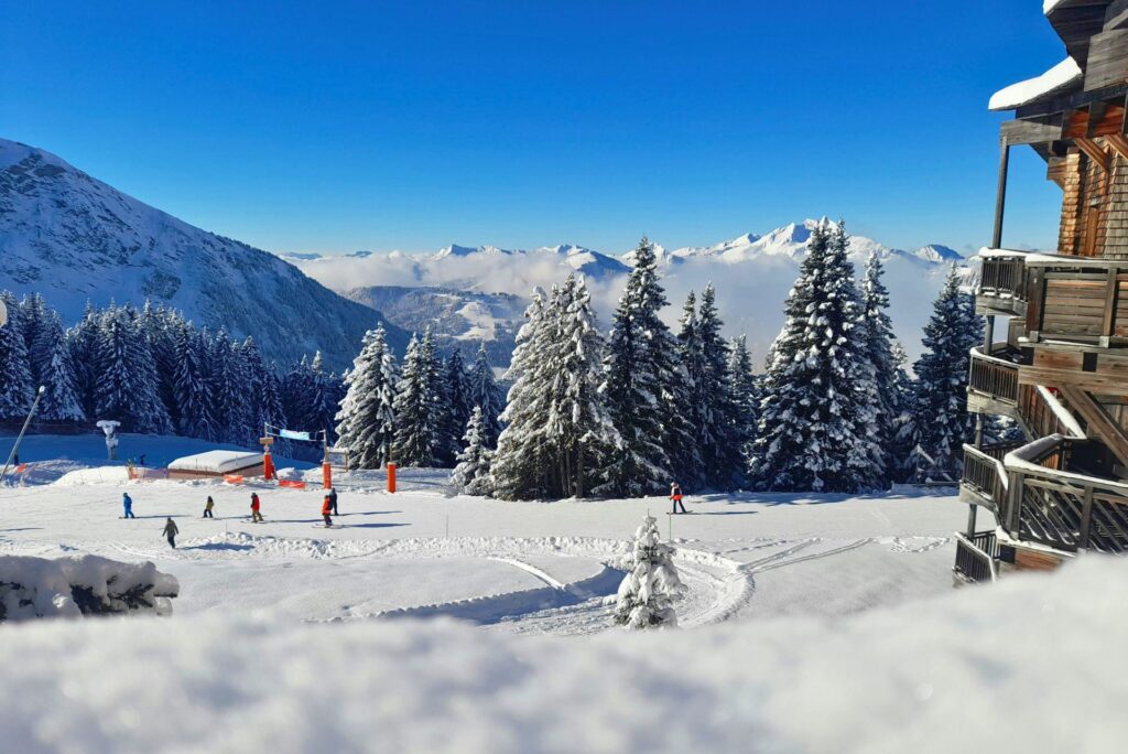 Several downhill skiers on a sunny day.