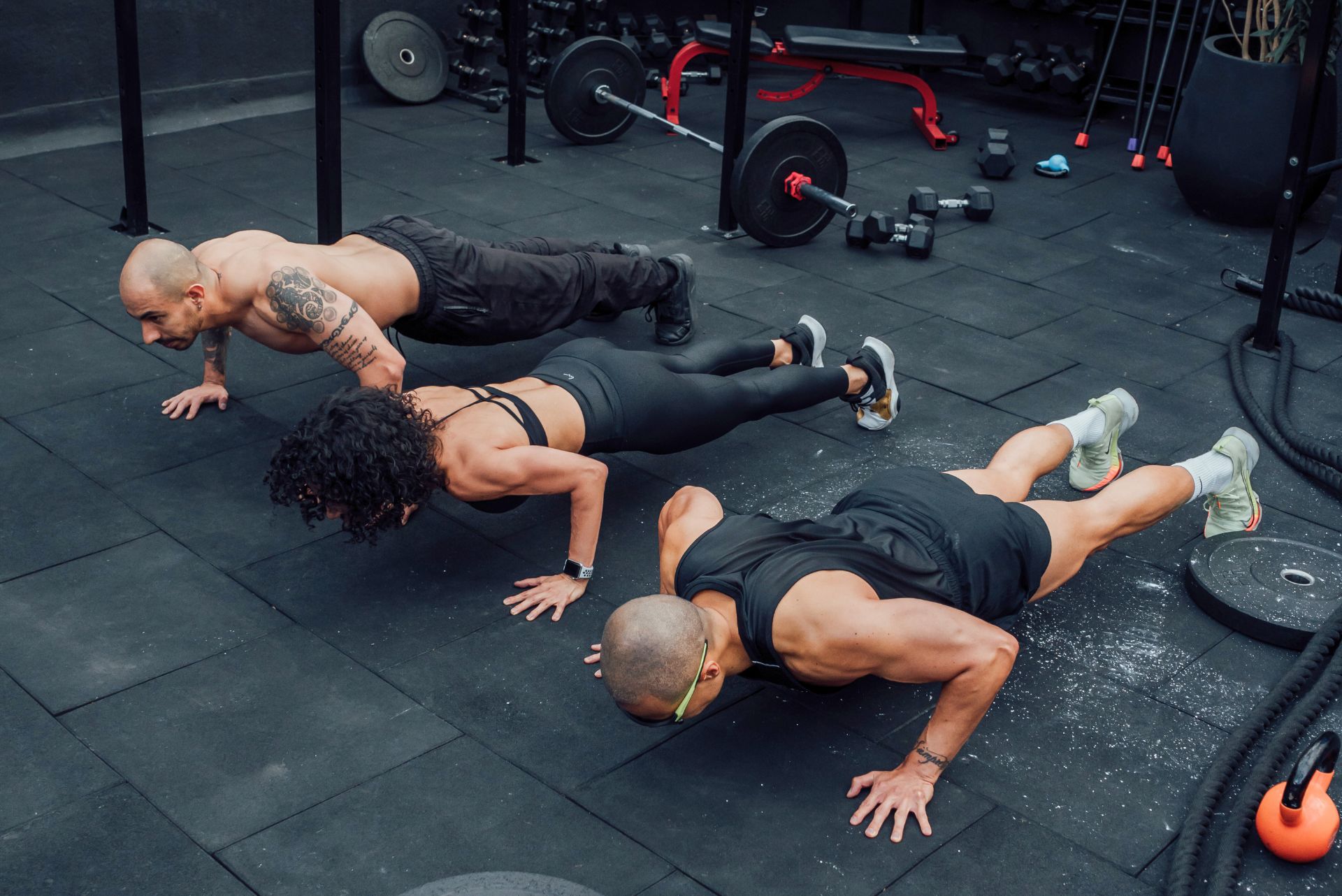 Three athletes doing strength training for endurance.